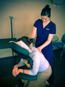 IBMC College Massage Therapy Degree Students Peform Chair Massages Through Training Learned at IBMC Massage Therapy School
